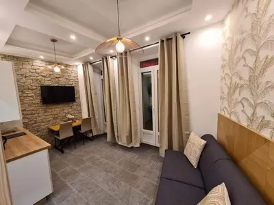 a living room with a couch and a table at BRILOC AJACCIO centre ville in Ajaccio
