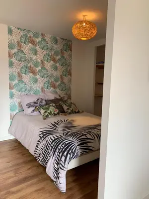 a bedroom with a bed with a zebra print wall at chez LULU appartement neuf au coeur de cozzano in Cozzano