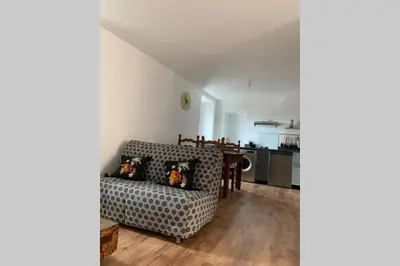a living room with a couch and a table at chez LULU appartement neuf au coeur de cozzano in Cozzano
