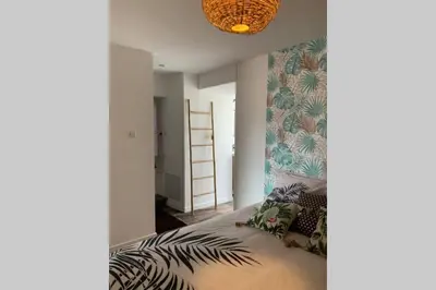 a bedroom with a bed with a leafy wall at chez LULU appartement neuf au coeur de cozzano in Cozzano