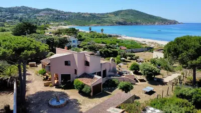 an aerial view of a house and the beach at Villa pieds dans l'eau, Casa d'Omigna, Corse du sud, Cargèse, in Cargèse