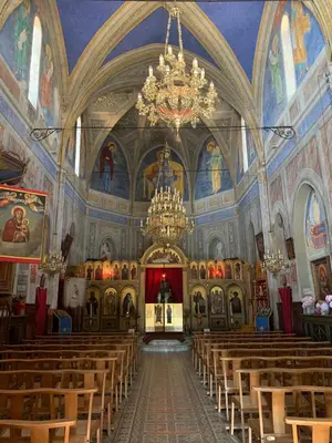 a large church with a chandelier in the middle at Villa pieds dans l'eau, Casa d'Omigna, Corse du sud, Cargèse, in Cargèse