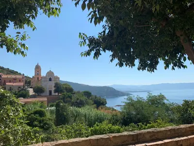a view of the ocean from a hill with a castle at Villa pieds dans l'eau, Casa d'Omigna, Corse du sud, Cargèse, in Cargèse