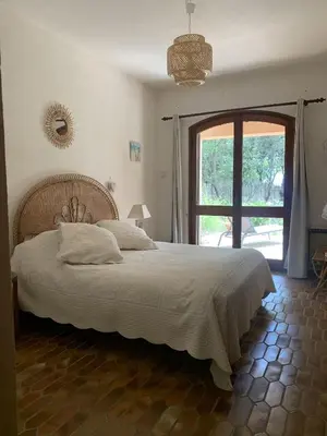 a bedroom with a large bed and a large window at Villa pieds dans l'eau, Casa d'Omigna, Corse du sud, Cargèse, in Cargèse