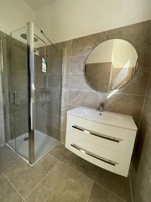 a bathroom with a sink and a shower and a mirror at Villa pieds dans l'eau, Casa d'Omigna, Corse du sud, Cargèse, in Cargèse