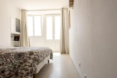 a bedroom with a bed and a window at CASA MONICA CARGESE - Swing 42 - appartement in Cargèse