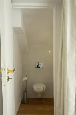 a bathroom with a white toilet in a room at CASA MONICA CARGESE - Swing 42 - appartement in Cargèse