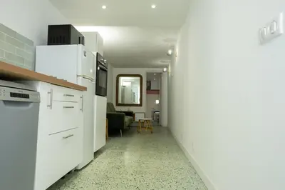 a kitchen with white appliances and a living room at CASA MONICA CARGESE - Swing 42 - appartement in Cargèse