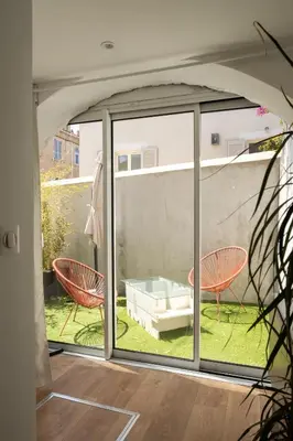 a room with a window and two chairs at CASA MONICA CARGESE - Swing 42 - appartement in Cargèse