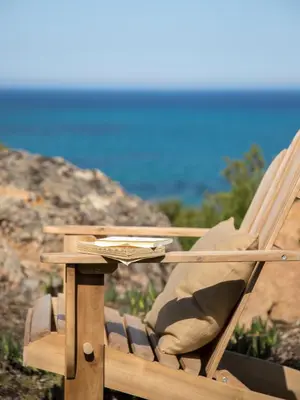 a wooden chair sitting on top of a table at Boutique hôtel Château Rouher in Propriano