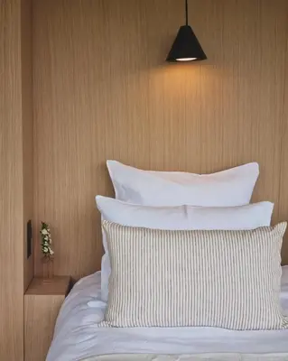 a bed with white pillows on top of it at Boutique hôtel Château Rouher in Propriano