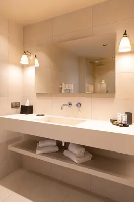 a bathroom with a large sink and a mirror at Boutique hôtel Château Rouher in Propriano