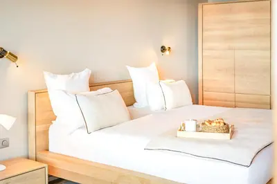 a bedroom with a large white bed with a box of candles at Boutique hôtel Château Rouher in Propriano