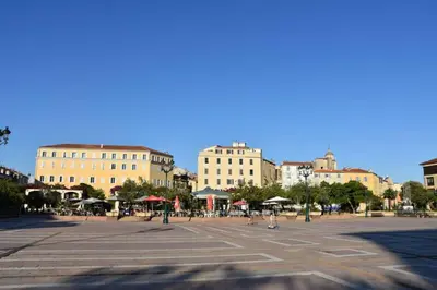 a large empty parking lot with buildings in the background at Appartement plein de charme - Ajaccio hyper centre in Ajaccio