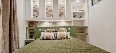 a bedroom with a bed with two pillows on it at Appartement plein de charme - Ajaccio hyper centre in Ajaccio