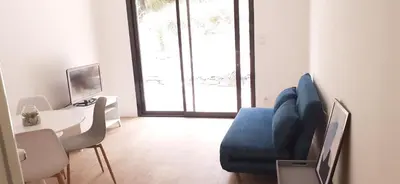 a living room with a blue couch and a table at Casa Prunelli in Omessa