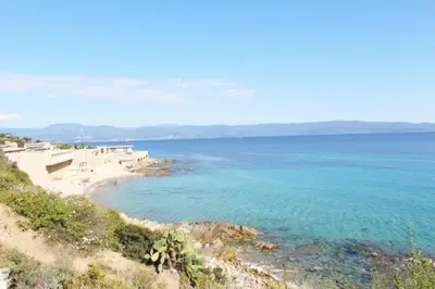 a view of a beach with the ocean at CosySeaside Corsica Ajaccio Piscine Terrasse Mer in Ajaccio