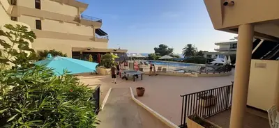 a view of a balcony of a building with a pool at CosySeaside Corsica Ajaccio Piscine Terrasse Mer in Ajaccio
