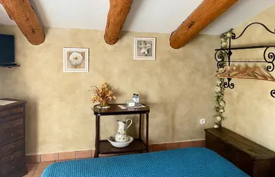 a bedroom with two beds and a mirror at Chambres d'hôtes et studios de charme - A Mandria in Murato