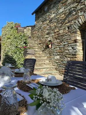 a wooden pergola with pillows on a patio at Chambres d'hôtes et studios de charme - A Mandria in Murato