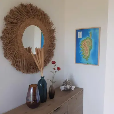 a mirror on top of a dresser with vases at Splendide appartement T3 piscine et vue mer in Grosseto-Prugna