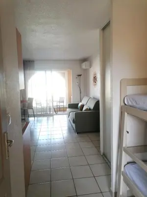 a living room with a couch and a floor at Studio 4 personnes bord de mer avec piscine wifi in Cervione