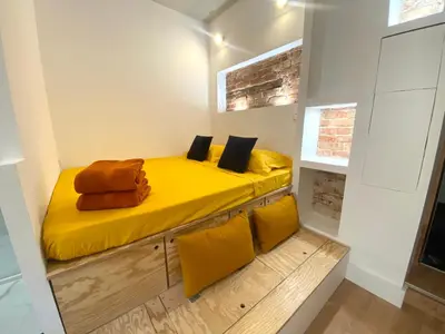 a bedroom with a yellow bed and yellow pillows at Studio d'architecte centre historique in Ajaccio