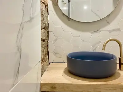 a blue sink in a bathroom with a mirror at Studio d'architecte centre historique in Ajaccio