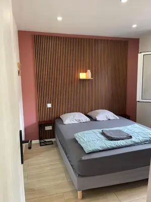 a bedroom with a bed and a shower curtain at Muratello Appart 1 in Porto-Vecchio