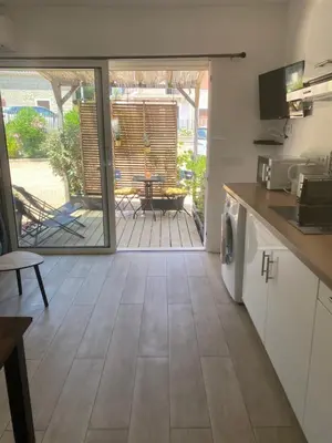 an open kitchen with a view of a patio at Muratello Appart 1 in Porto-Vecchio