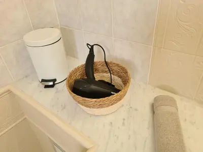 a basket sitting on top of a counter in a bathroom at Les Terrasses de Sari in Sari Solenzara