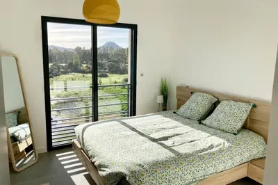 a bedroom with a bed and a large window at Appartement magnifique - Luxe - Proche du port - 1 chambre - Pour des vacances paisibles in Porto-Vecchio