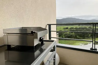 a grill on a balcony with a view at Appartement magnifique - Luxe - Proche du port - 1 chambre - Pour des vacances paisibles in Porto-Vecchio