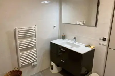 a bathroom with a sink and a mirror at Appartement magnifique - Luxe - Proche du port - 1 chambre - Pour des vacances paisibles in Porto-Vecchio