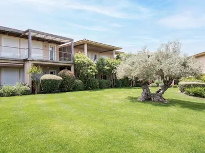 a house with a green yard with trees and bushes at Apartment Côté Plage by Interhome in Sainte-Lucie de Porto-Vecchio