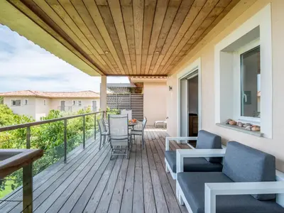 a deck with chairs and a table on a house at Apartment Côté Plage by Interhome in Sainte-Lucie de Porto-Vecchio