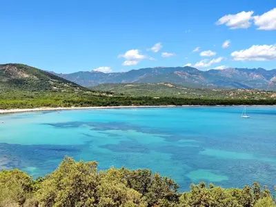 a view of a beach with a boat in the water at Apartment Côté Plage by Interhome in Sainte-Lucie de Porto-Vecchio