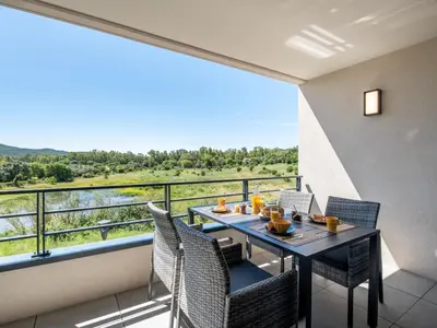 a balcony with a table and chairs and a view at Apartment Stanatura-3 by Interhome in Porto-Vecchio