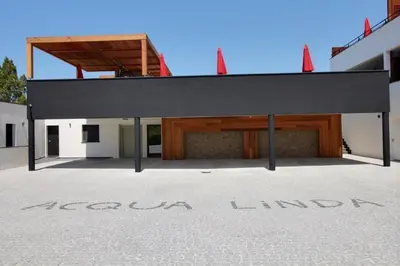 a building with a black roof and a garage at STUDIO PORTICCIO AGOSTA PLAGE in Porticcio