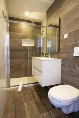 a bathroom with a toilet and a sink and a shower at STUDIO PORTICCIO AGOSTA PLAGE in Porticcio