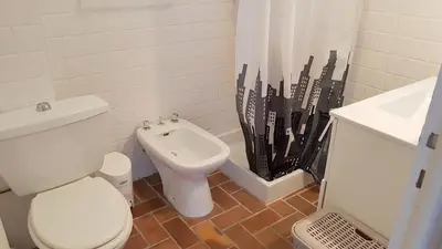 a bathroom with a white toilet and a sink at CYSTES in Kamiesch