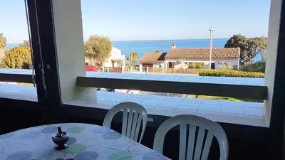 a dining room with a view of the ocean at CYSTES in Kamiesch