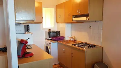 a small kitchen with a stove and a microwave at CYSTES in Kamiesch