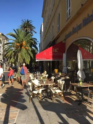 a group of tables and chairs in front of a building at AJACCIO CENTRE VIEILLE VILLE IMPÉRIALE TT CONFORT TTES COMMODITÉS 3 a 4 PERs CATHÉDRALE A 300M MER PORT MARCHE LOCAL PLAGES in Ajaccio