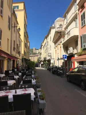 an empty street with tables and chairs on a city street at AJACCIO CENTRE VIEILLE VILLE IMPÉRIALE TT CONFORT TTES COMMODITÉS 3 a 4 PERs CATHÉDRALE A 300M MER PORT MARCHE LOCAL PLAGES in Ajaccio
