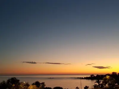 a sunset view of the ocean with the sky at AJACCIO CENTRE VIEILLE VILLE IMPÉRIALE TT CONFORT TTES COMMODITÉS 3 a 4 PERs CATHÉDRALE A 300M MER PORT MARCHE LOCAL PLAGES in Ajaccio