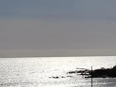 a large body of water with the sun shining on it at AJACCIO CENTRE VIEILLE VILLE IMPÉRIALE TT CONFORT TTES COMMODITÉS 3 a 4 PERs CATHÉDRALE A 300M MER PORT MARCHE LOCAL PLAGES in Ajaccio