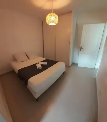 a bedroom with a bed with a black and white blanket at Casa Prunelli 2 in Omessa