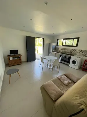 a living room with a couch and a table at Casa Prunelli 2 in Omessa