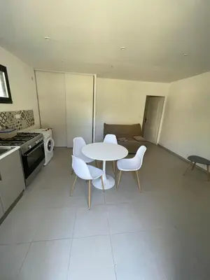 a kitchen with a table and chairs and a stove at Casa Prunelli 2 in Omessa